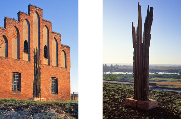 Edward Dormer's wooden sculpture against medieval red brick Teutonic castle wall in Gniew, Poland, contrasting ancient materials