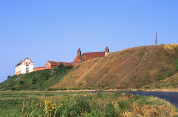 Historic Teutonic castle in Gniew, Poland, site of Edward Dormer's Segue sculptures, perched on hillside overlooking Vistula River Valley