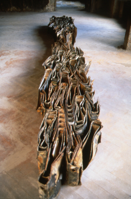 One Day Four Hours: Tug of War installation at Schiffbauergasse Potsdam by Edward Dormer, displaying burnt paper documents arranged in a line on a wooden floor, representing historical erasure in post-reunification Germany. 