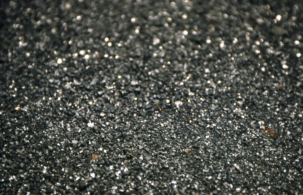 Close-up of anthracite material in Minefield installation - sparkling carbon surface representing hidden tension in Philadelphia art exhibit