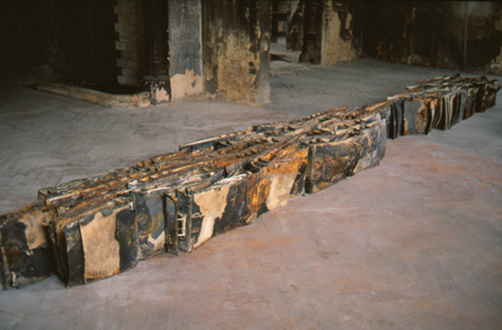 Detail view of One Day Four Hours: Tug of War by Edward Dormer at Schiffbaubauergasse Potsdam, revealing the texture and deterioration of burnt documents, highlighting the fragility of institutional records.